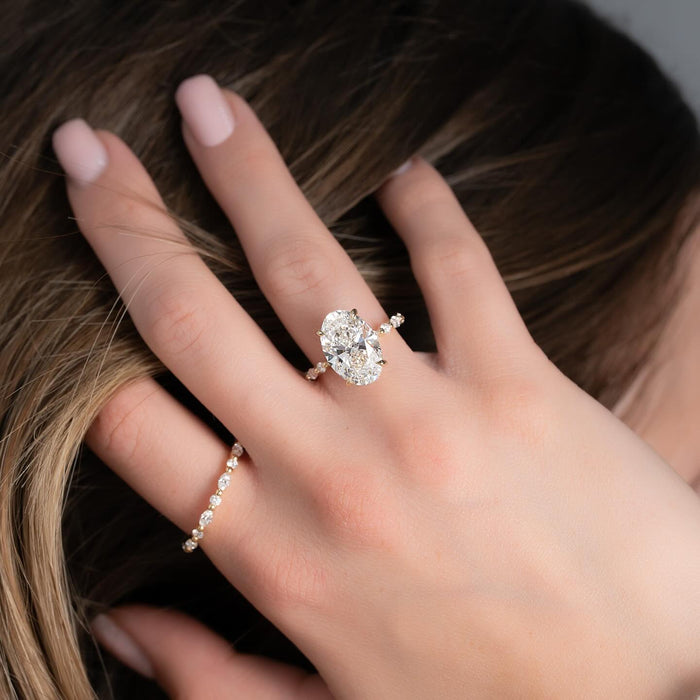 Oval lab grown diamond engagement ring worn on the hand