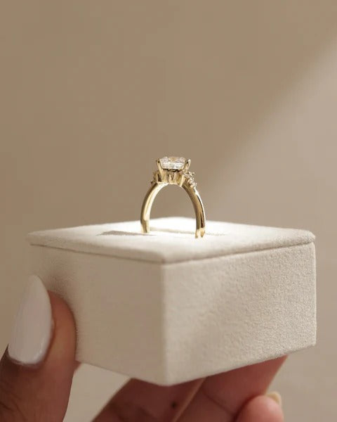 Princess cut diamond turned on the diagonal with staggered shoulder accents