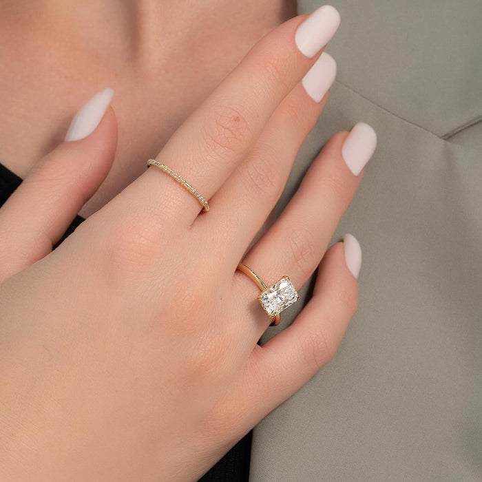 Radiant cut solitaire engagement ring worn on the hand