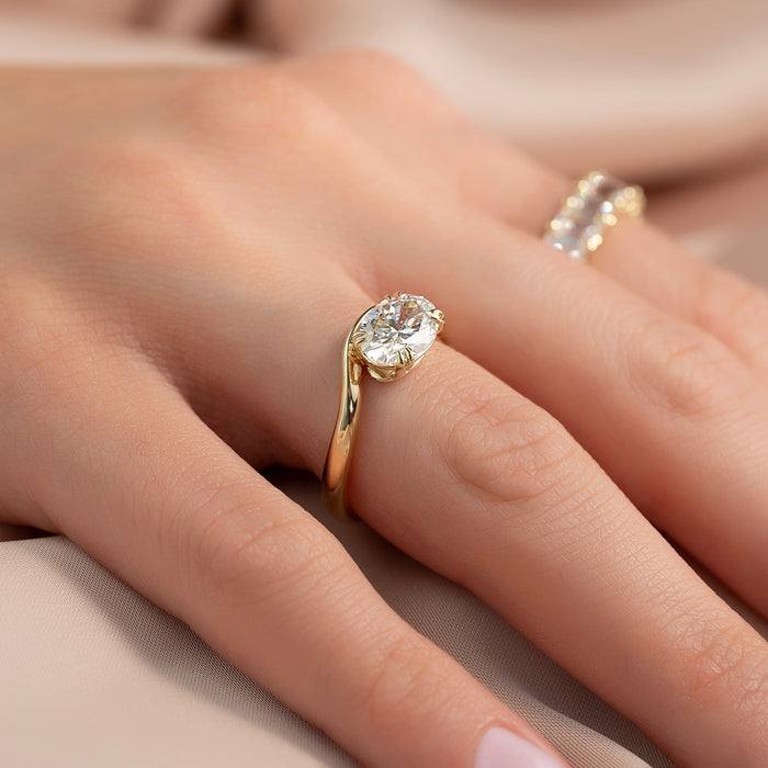 Bypass setting oval diamond ring worn on hand