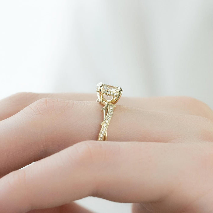 Profile of the carved vine shank with pave thorns beneath an oval lab grown diamond