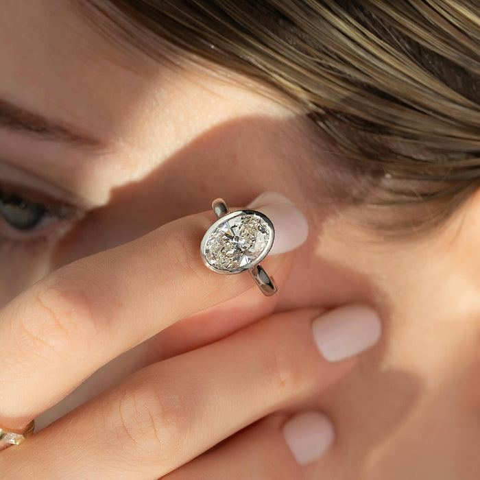Fine bezel rim following the girdle line of the oval diamond