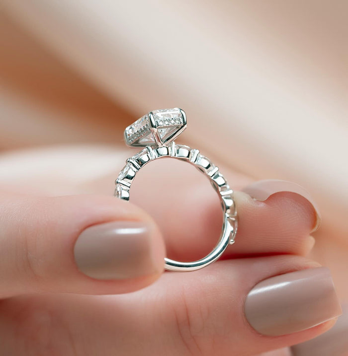 Close view of the crosswise marquise and round accents beside the radiant cut diamond