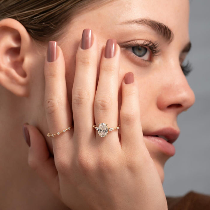 Pear and round accent diamonds beside the oval centre stone