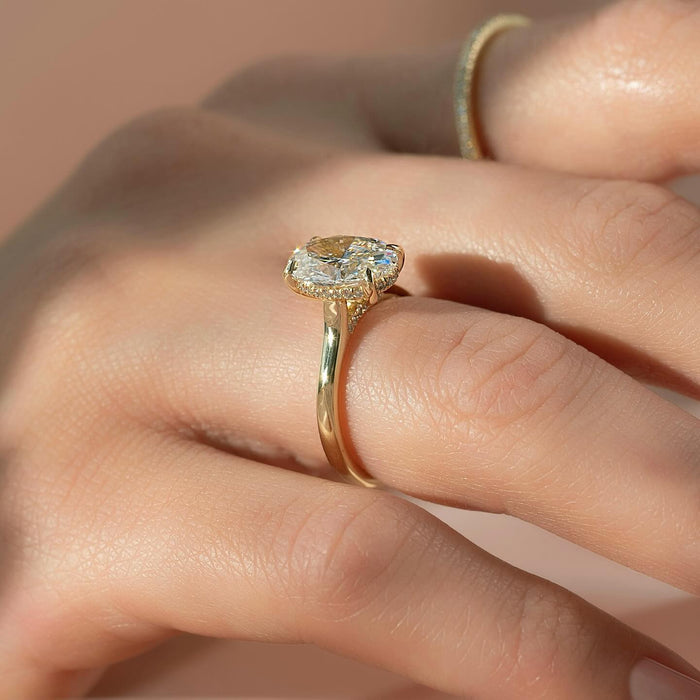 Profile of oval diamond ring showing hidden halo under the basket