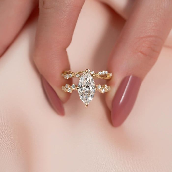 Contoured vine wedding band nesting with the marquise engagement ring