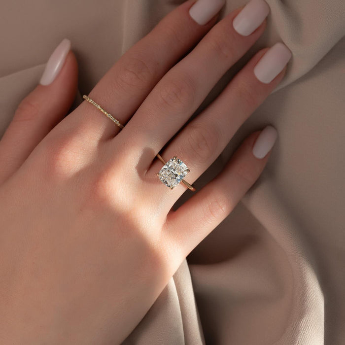 Four claw open basket holding the cushion cut lab grown diamond