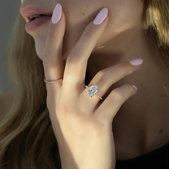 Oval diamond engagement ring with pave shoulders
