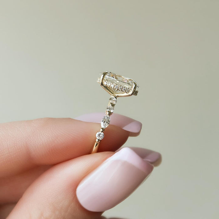 Oval cut lab grown diamond ring in yellow gold with spaced oval and round accents