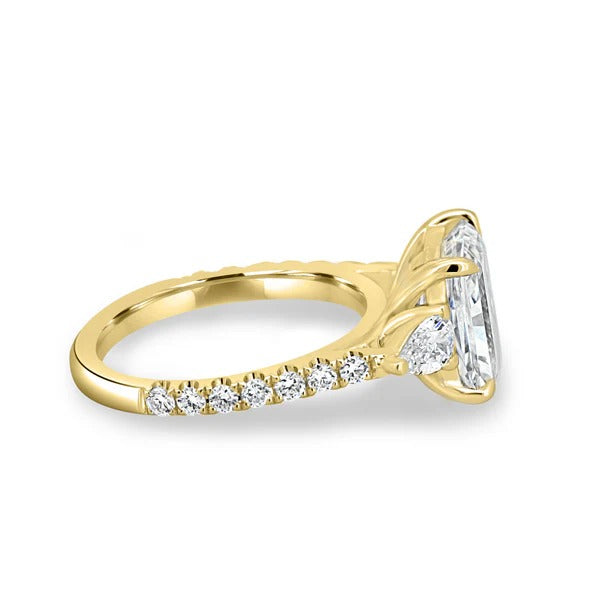 Radiant cut diamond trilogy ring with pear side stones side profile