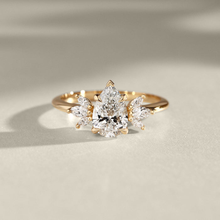 Pear cut lab grown diamond ring with fanned marquise and pear accents in yellow gold