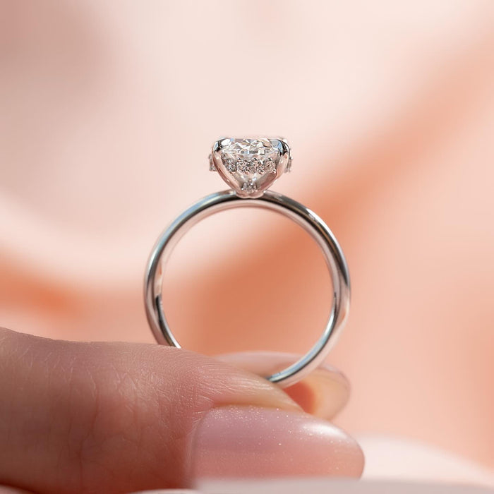 Oval moissanite hidden halo petite band ring side profile in white gold
