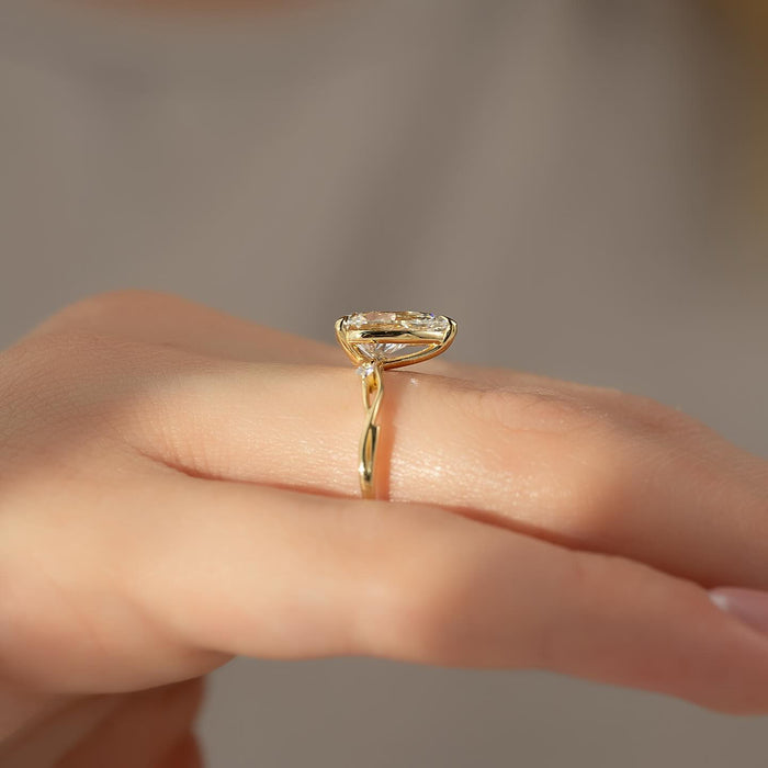 Pear moissanite vine ring side profile in yellow gold