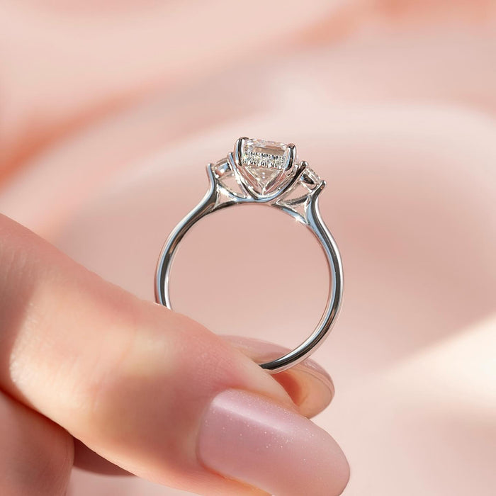 Emerald cut moissanite round side stone ring side profile in white gold
