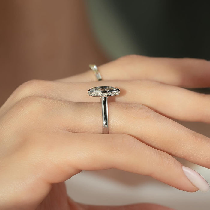 Side profile of oval moissanite bezel ring showing hidden halo and slim band