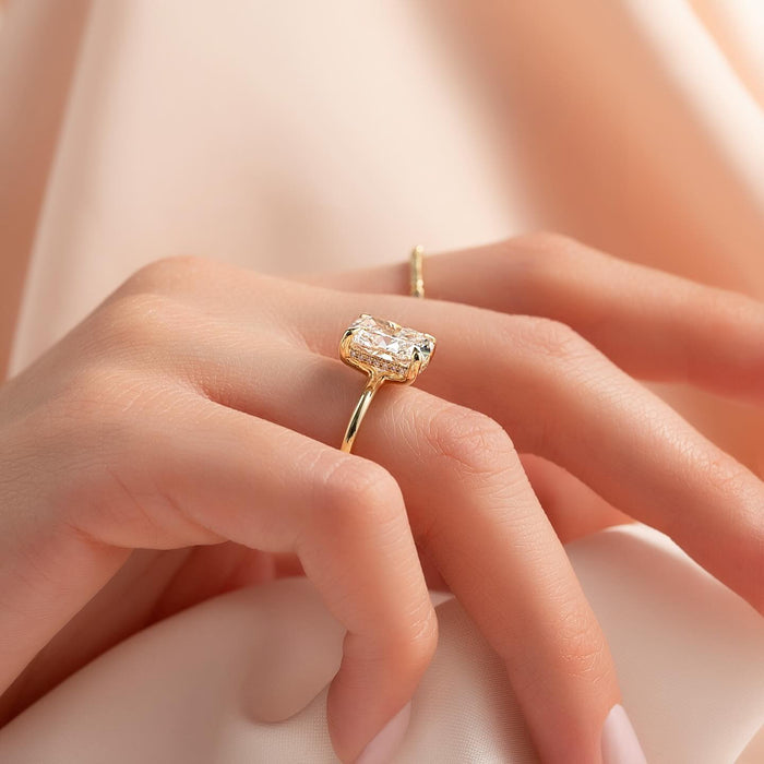 Side profile of elongated cushion moissanite ring showing hidden halo pave