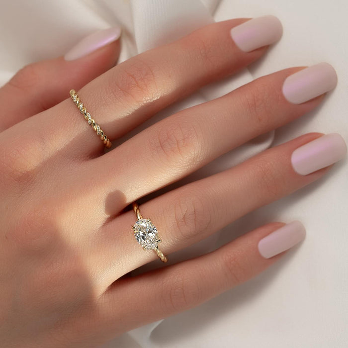 Model wearing oval moissanite east west twisted rope band engagement ring