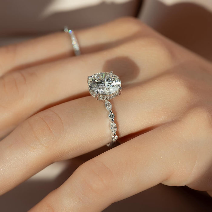 Round moissanite hidden halo ring with marquise accent band in white gold
