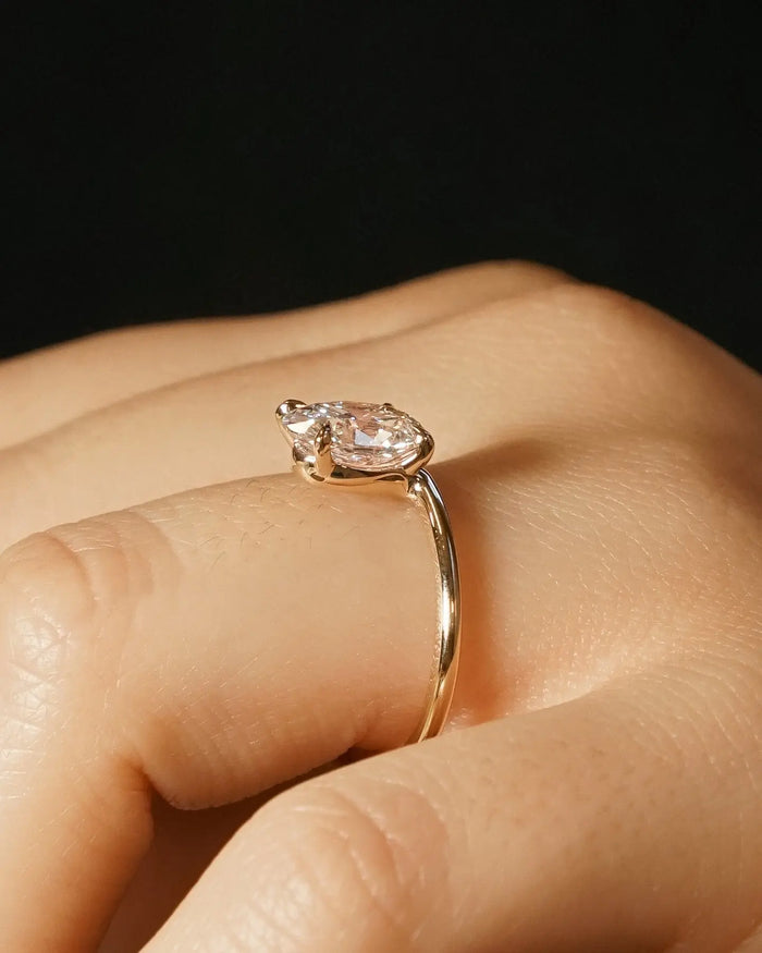 Oval moissanite solitaire bridal ring, angled view