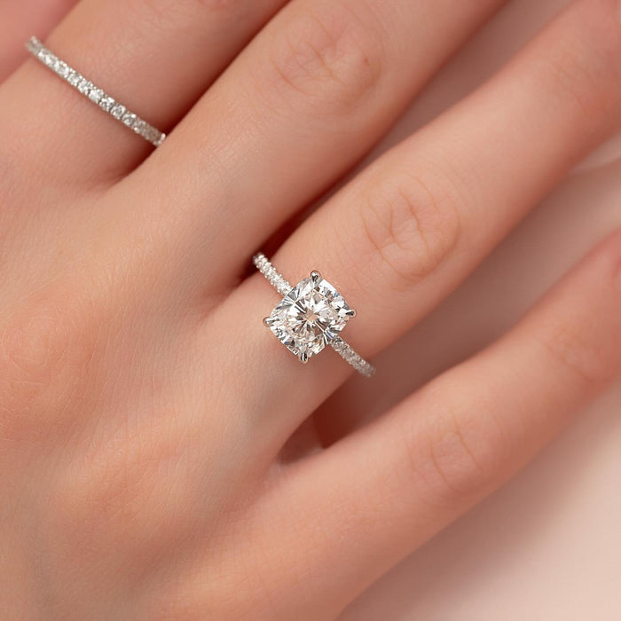 Cushion Cut Moissanite Hidden Halo Pave Shank Ring in 14K Gold on hand