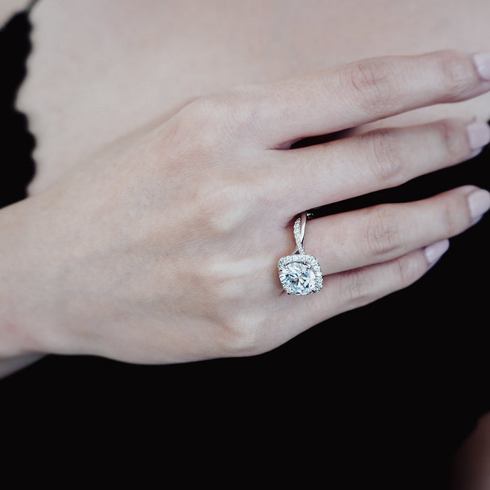 Twisted shank halo engagement ring seen on the finger