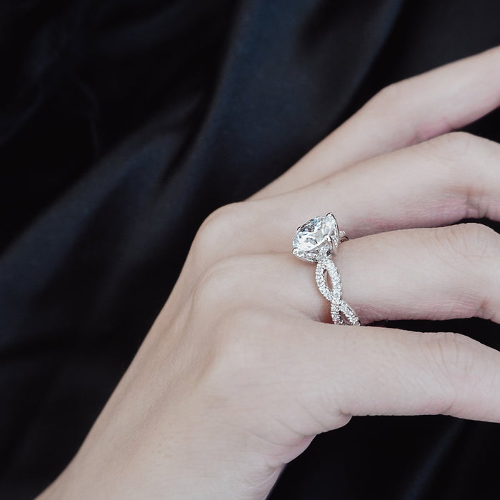 Criss cross woven band engagement ring on the finger