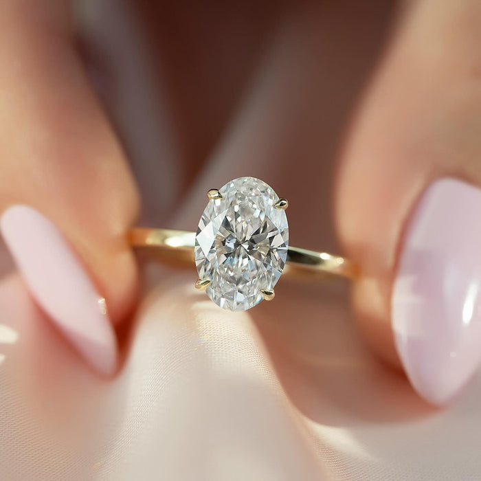 Oval Moissanite Four Prong Solitaire Ring on hand in 14K Gold