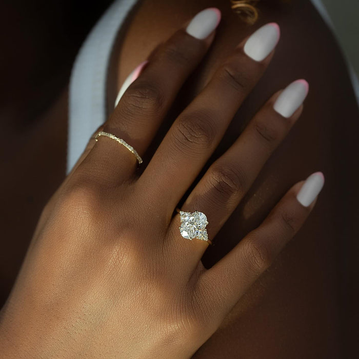 Oval Moissanite Trio Cluster Accent Solitaire Ring on hand in 14K Gold