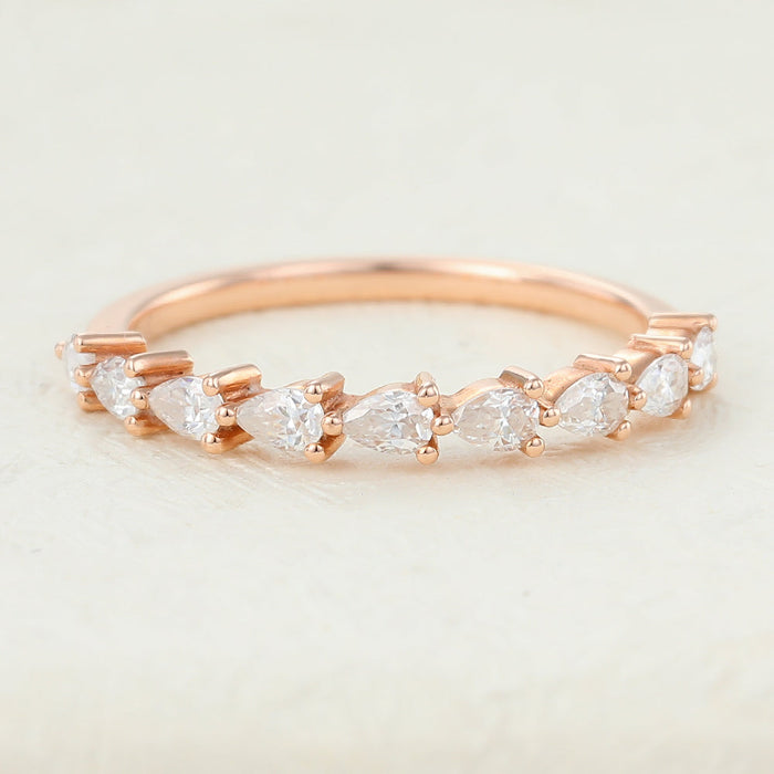 Rose gold half eternity band with pear shaped moissanite stones set along the band, front view