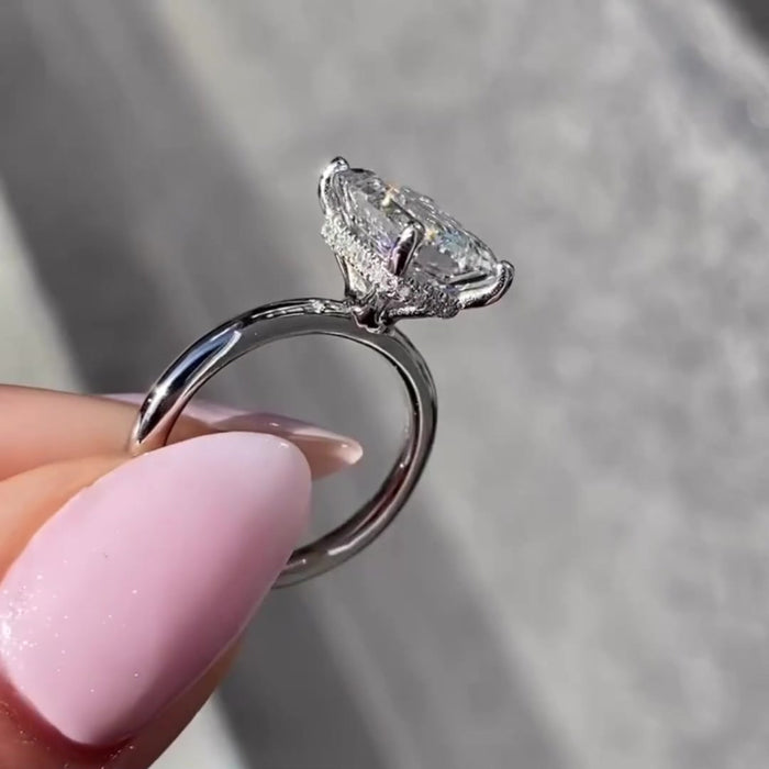 Hidden halo emerald cut moissanite bridal ring, angled view