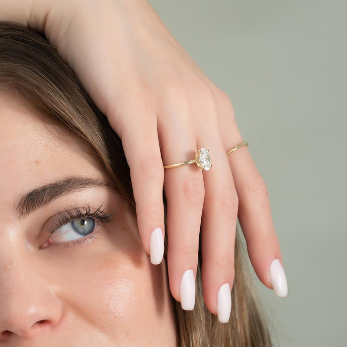 Oval Cut Moissanite Lotus Basket Hidden Halo Ring — on finger — Mapple Gems