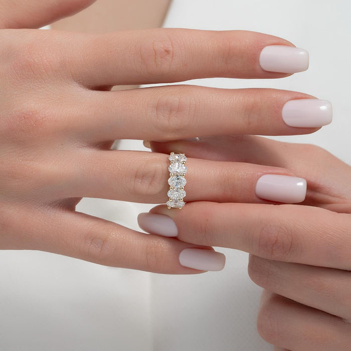 Oval moissanite half eternity band worn on hand