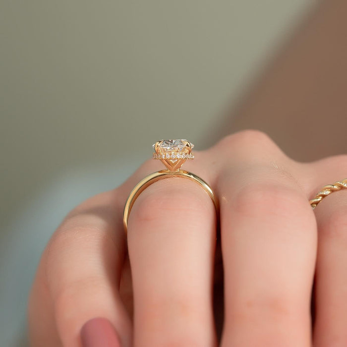 Side view of oval moissanite ring showing hidden halo and plain band