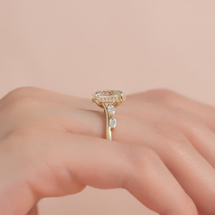 Side view of oval moissanite ring showing hidden halo and marquise accent bypass band