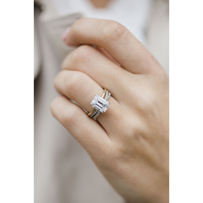 Cross over pave wedding band worn with a separate emerald cut engagement ring, the engagement ring is not included
