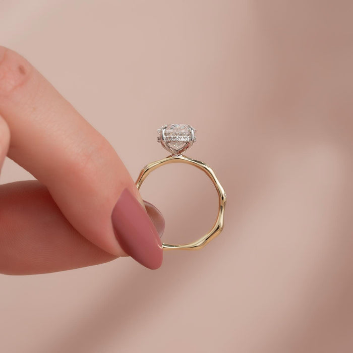 Oval cut moissanite hidden halo bamboo band ring side profile in 14K gold