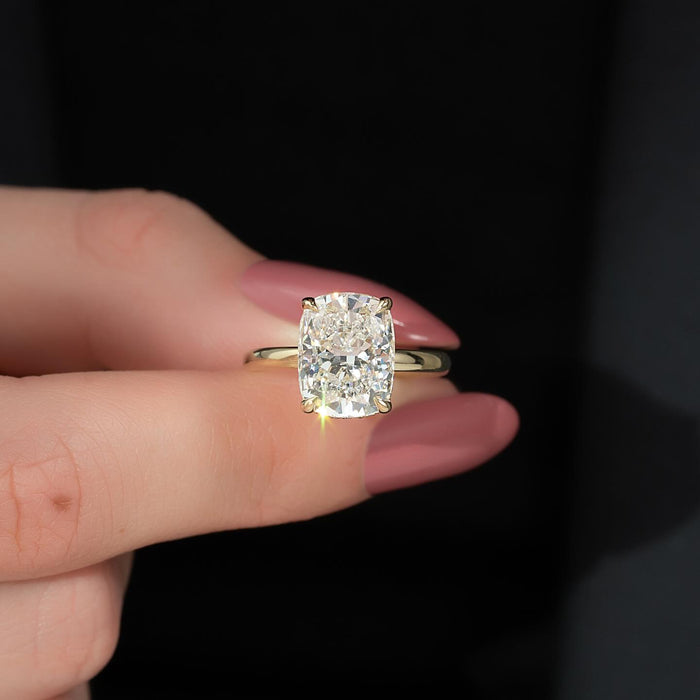 Elongated cushion moissanite solitaire ring front view on hand