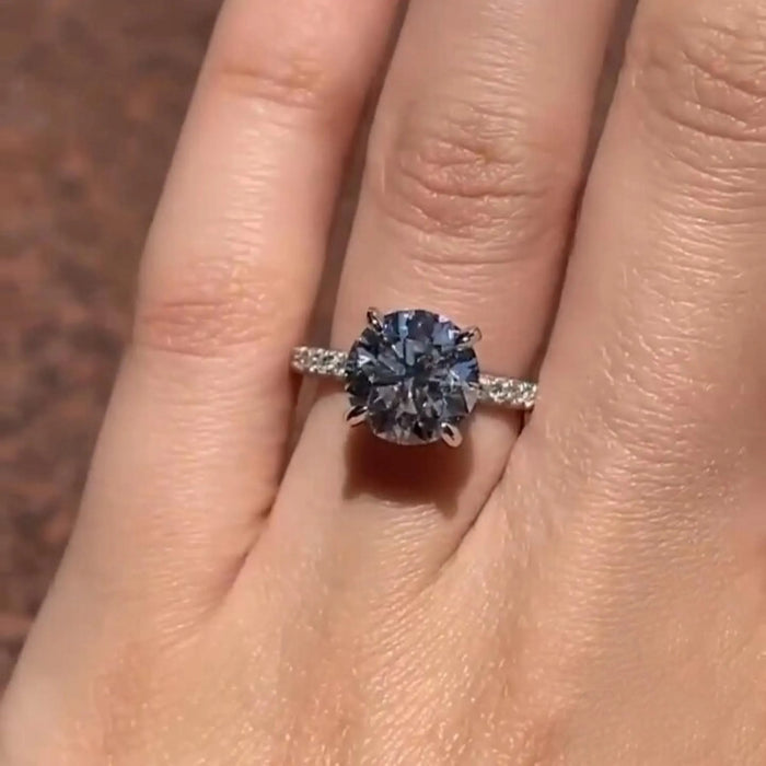 Round moissanite hidden halo pave ring on hand in 14K white gold — Mapple Gems