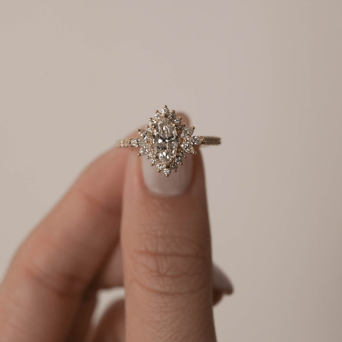 Marquise cut moissanite cluster halo engagement ring on hand, front view