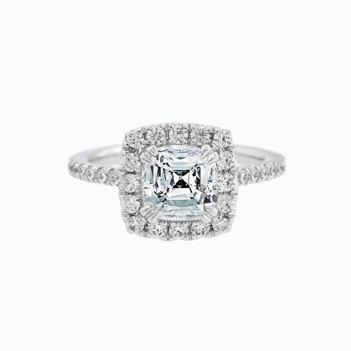 Cushion cut moissanite double halo engagement ring set in gold