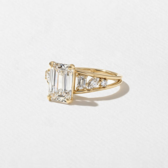 Angled view of the emerald cut lab grown diamond and clustered shoulders