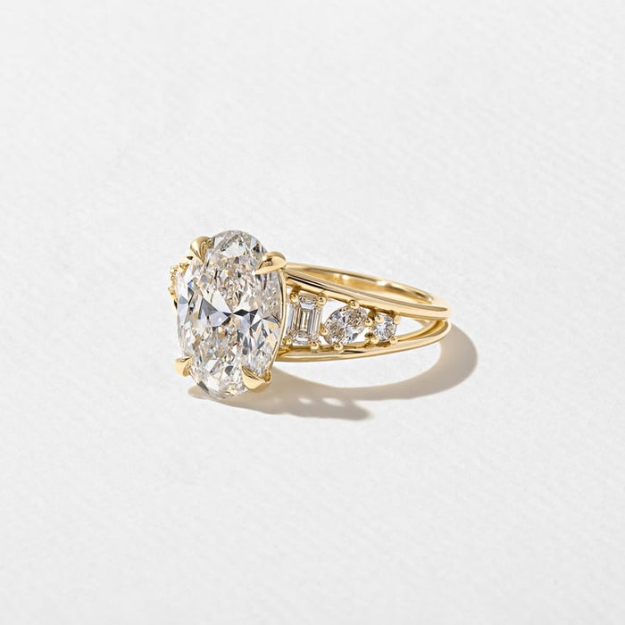 Angled view of the oval cut lab grown diamond and clustered shoulders