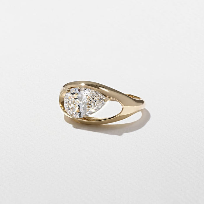 East west pear cut lab grown diamond split shank engagement ring in yellow gold