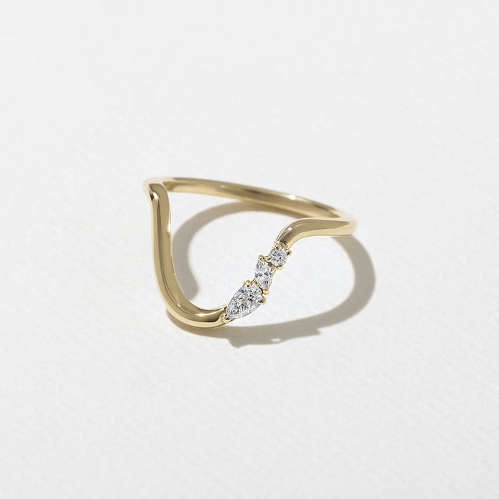 Pear, marquise and round moissanite stones on a curved band