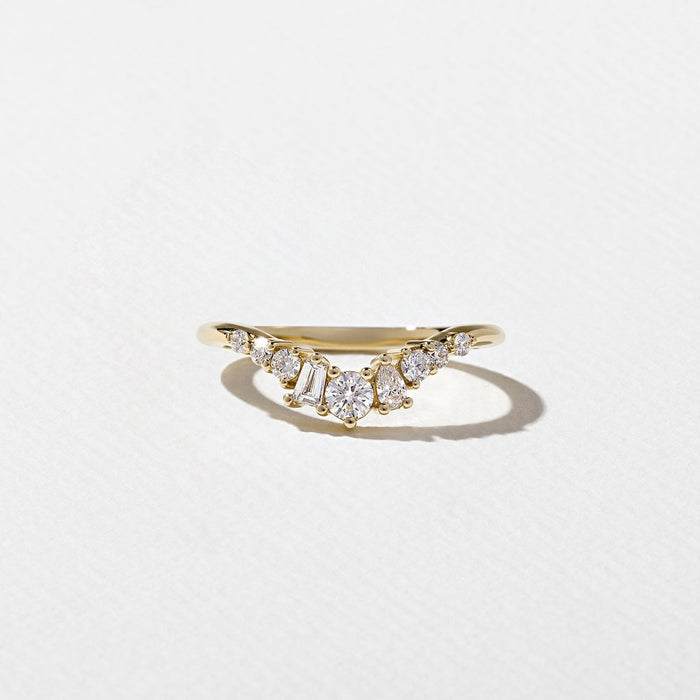 Curved cluster moissanite wedding band in yellow gold