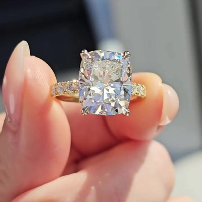 Elongated cushion moissanite ring with pave band, angled view