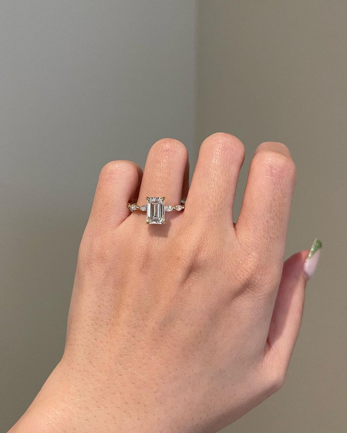 Handmade emerald shape moissanite ring, angled view