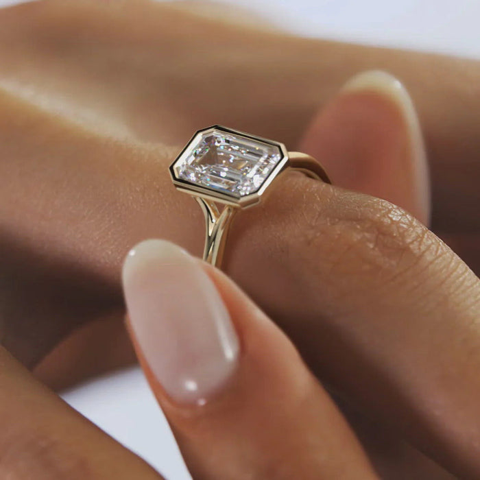 Elegant emerald cut moissanite solitaire ring, angled view