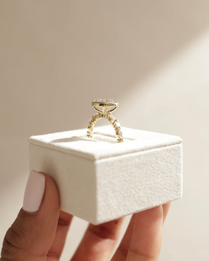 Oval Cut Moissanite Bezel Set Engagement Ring with Marquise and Round Accents - view 2