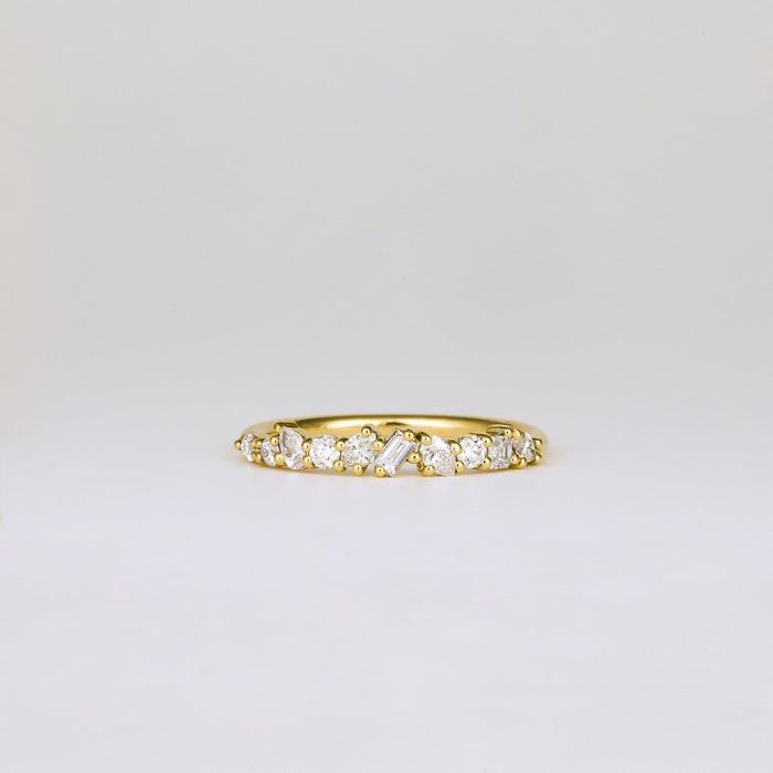 Front view of a mixed shape moissanite cluster band in yellow gold